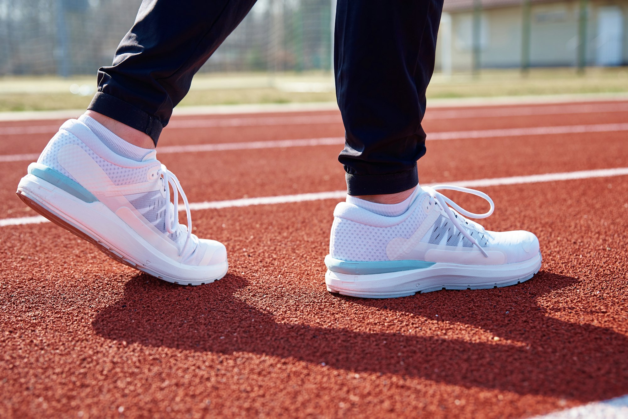 Runner feet running at sport stadium track